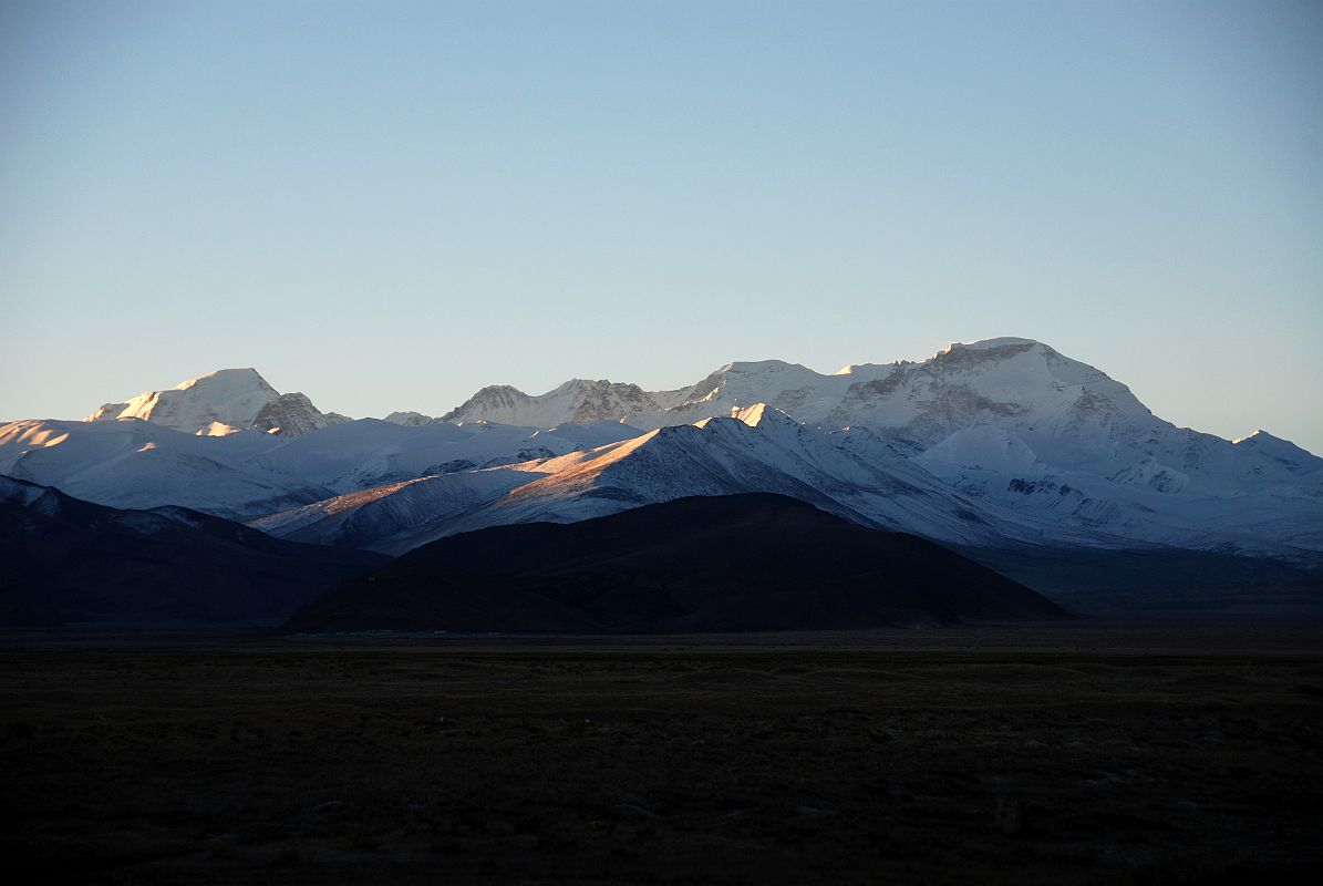 03 Gyachung Kang Ridge To Cho Oyu At Sunrise From Across Tingri Plain A long ice ridge connects Gyachung Kang (7952m) to Cho Oyu (8201m) from Tingri at sunrise.